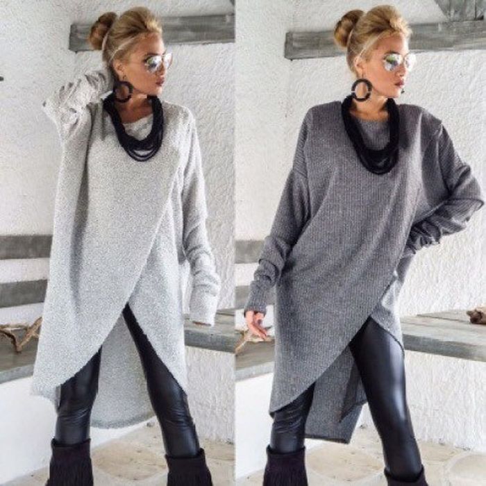 A model wearing a midi-length sweater dress layered over leather leggings