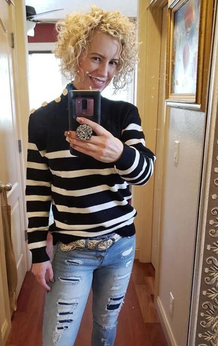 A reviewer wearing the sweater in a classic black and white design