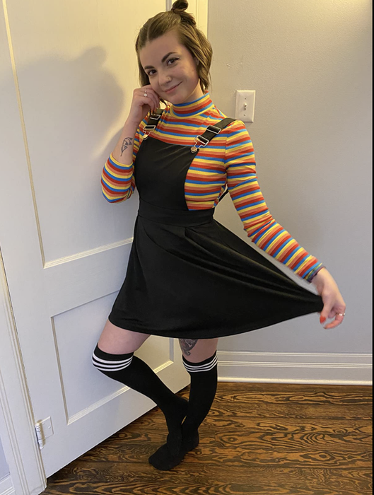A reviewer wearing the multi-colored turtleneck paired with a black dress