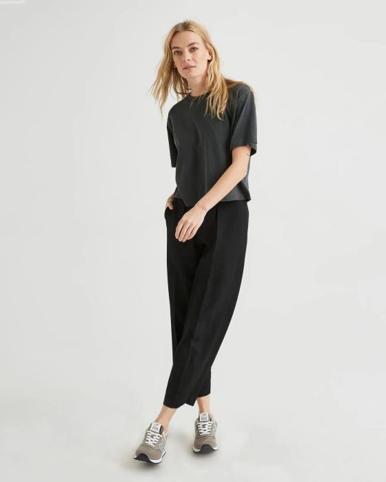A model is shown wearing a black relaxed crop top.