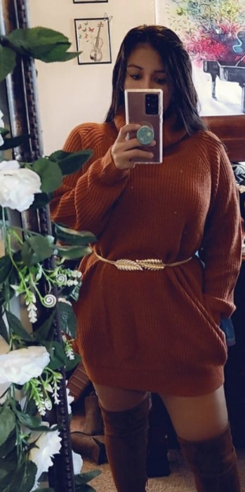 A reviewer photo showcasing the brown dress worn without tights and paired with knee-high boots