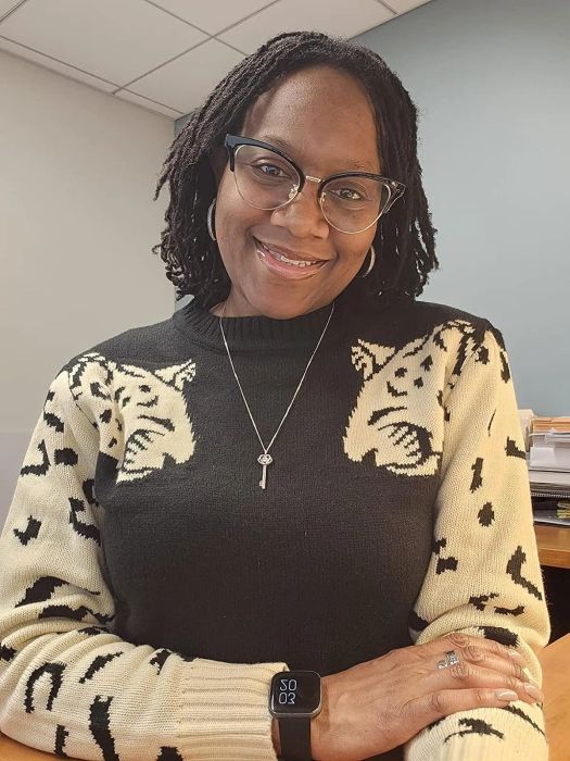 a reviewer showcasing the sweater in a sleek black color