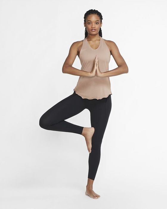a model performing the tree pose in the Nike Yoga Luxe leggings