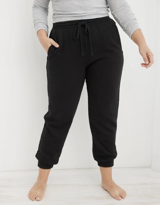 model wearing black drawstring joggers