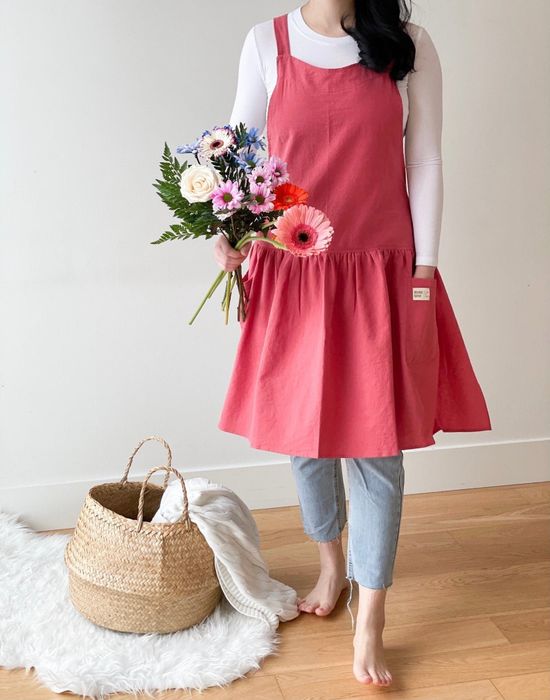 A person wearing a loose dress styled with leggings and a turtleneck underneath