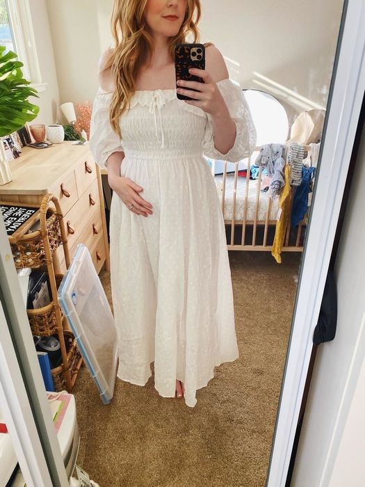 a reviewer sharing a mirror selfie in the white A-line dress