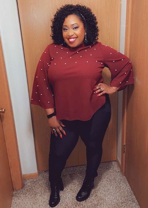 Reviewer sporting a long-sleeve burgundy shirt with slits, extending past the waist