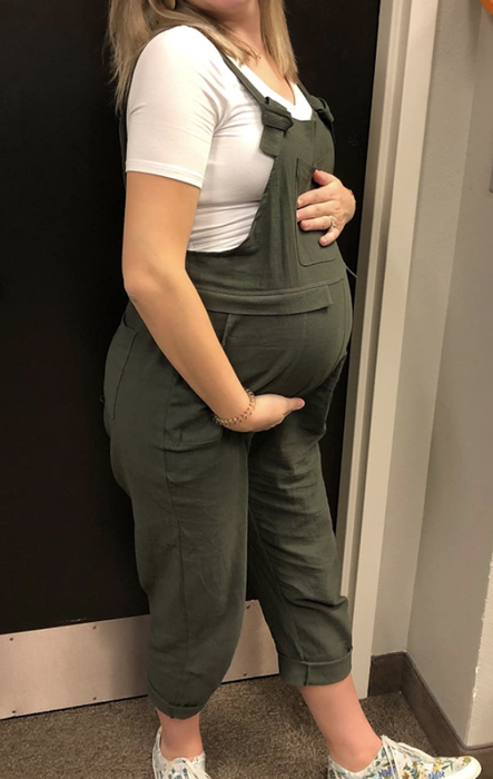 pregnant reviewer showcasing overalls