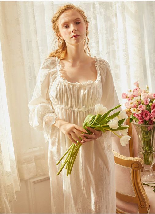 a model wearing the white Victorian cotton square nightgown, holding a bouquet of tulips