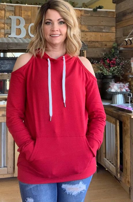a reviewer wearing the sweatshirt in a bold red shade