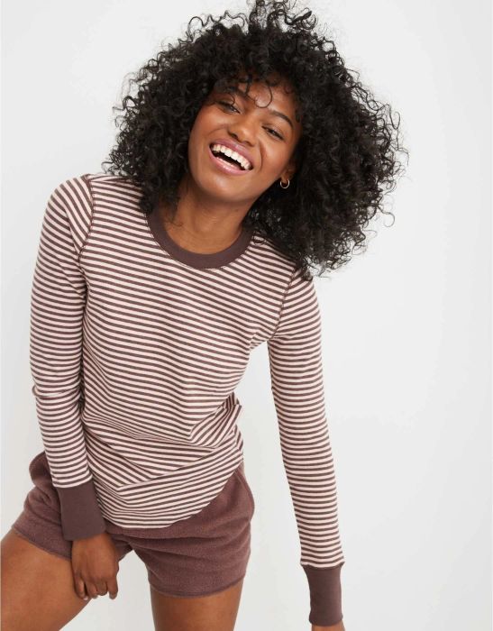 model in a brown and cream round-neck striped long sleeve tee