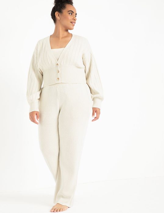 a plus-size model showcasing the full knit set in antique white