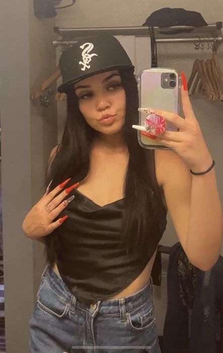 A mirror selfie of the reviewer wearing a black scarf top.