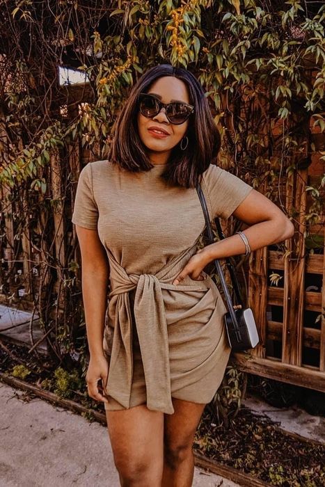 a reviewer modeling the tan dress