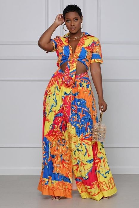 a model showcasing a multicolor printed maxi dress with short sleeves and a front stomach cutout