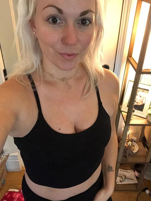 A reviewer takes a selfie in a black workout top.