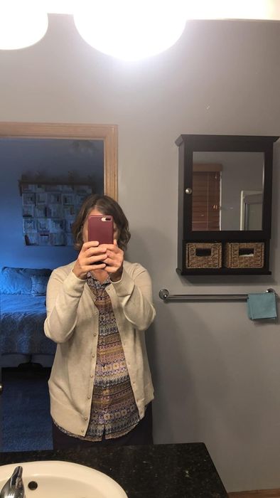 A photo of the reviewer wearing the sweater, showcasing its perfect fit and cozy style.