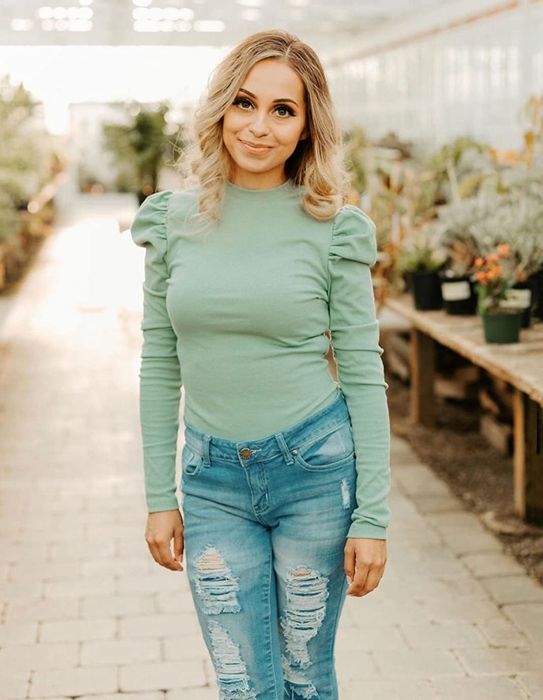 Reviewer wearing a mint-colored top