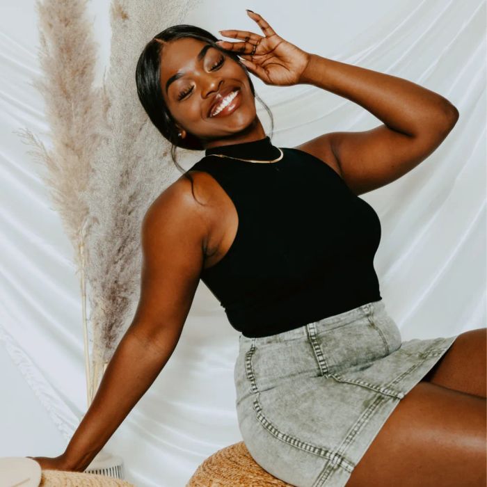 A model wearing a mock turtleneck tank top.