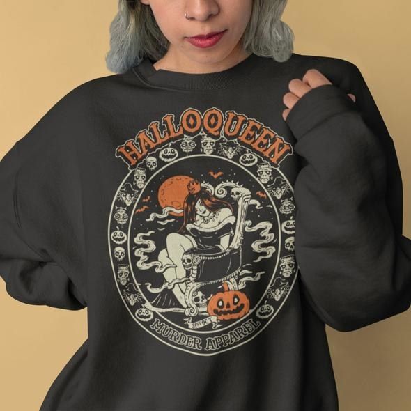 A model wearing a black sweatshirt featuring a jack-o’-lantern design and the word Halloqueen