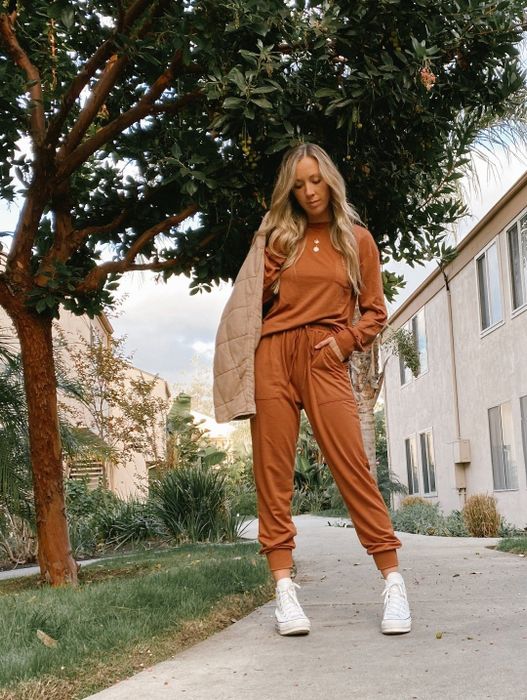 A reviewer styling the camel-colored set