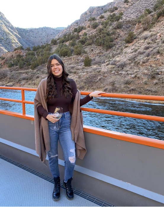 a reviewer photo in a brown mock turtleneck bodysuit