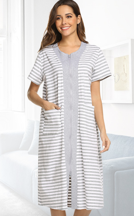 a model sporting the Ekouaer zipper-front housecoat in white, with one hand casually tucked into a pocket