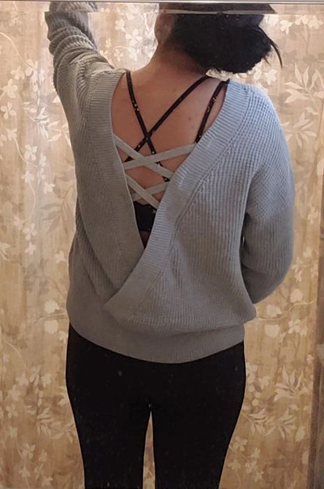 a reviewer photo showcasing a back V cutout on a gray sweater