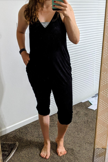 A reviewer wearing the v-neck, spaghetti-strap jumpsuit