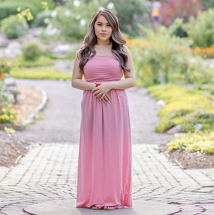 a reviewer wearing a pink strapless maxi dress