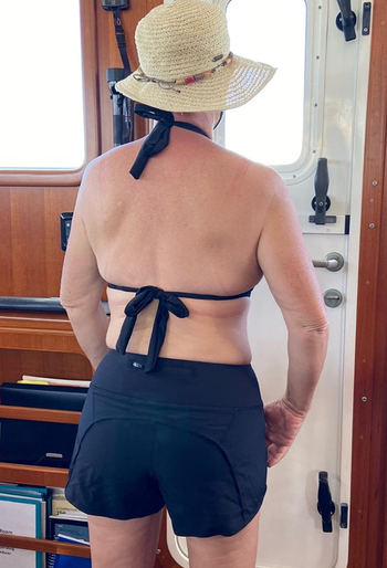 A reviewer is seen wearing a black pair, showcasing the panel seams on the back.