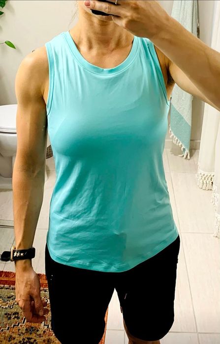 A reviewer modeling the blue top paired with black bottoms