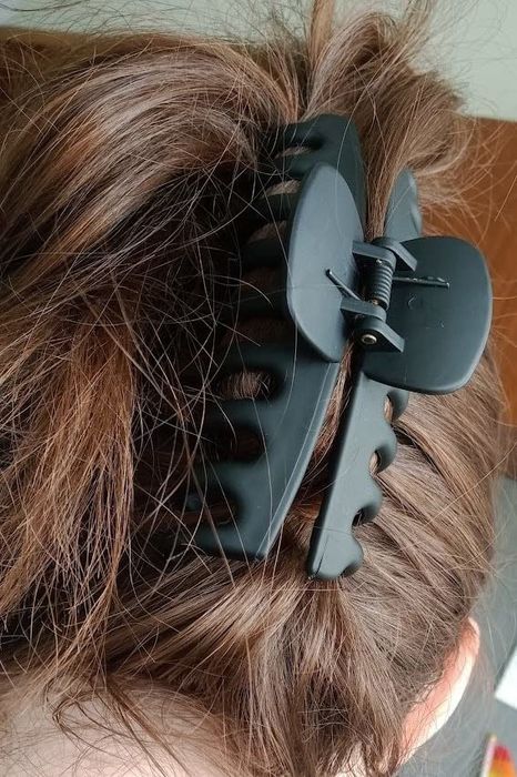 A reviewer wearing the green hair clip