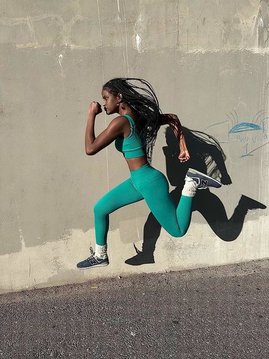 A reviewer showcasing the green workout set