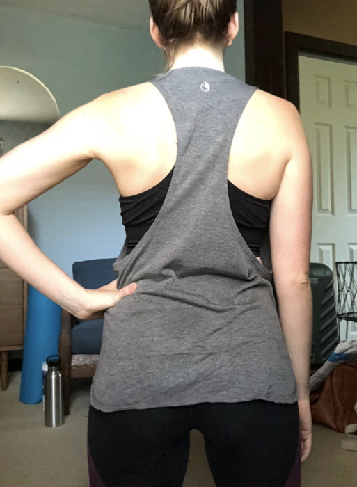 A reviewer is seen wearing the gray version, showcasing the deep racerback cut from behind.