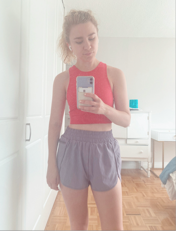 A Mytour editor models high-waisted elastic purple shorts.