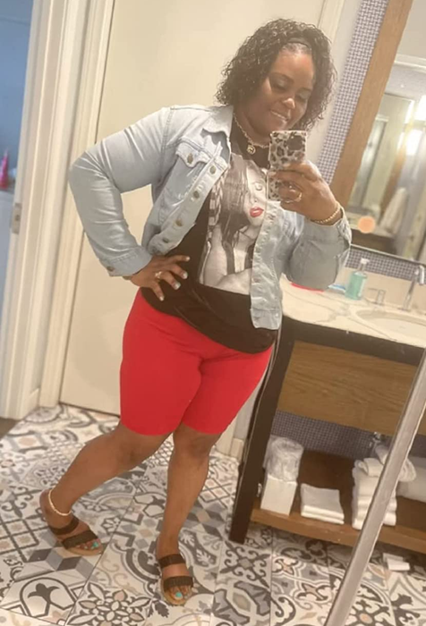 A reviewer modeling red biker shorts
