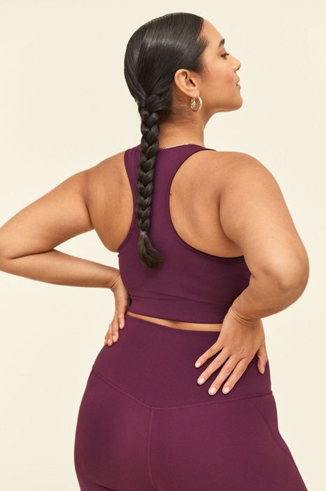 A model showcases the purple version, highlighting the racerback design.