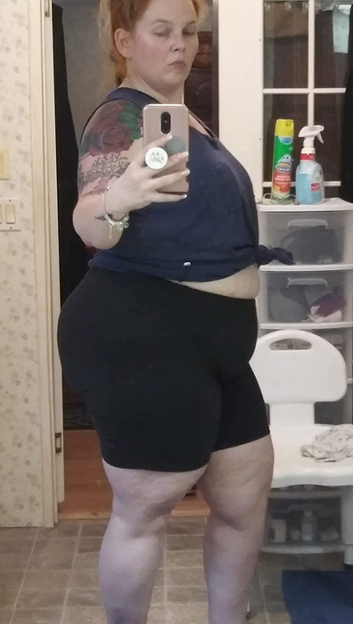 A reviewer modeling black biker shorts