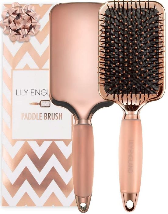 Rose gold paddle brush set featuring zigzag-patterned packaging with a bow, labeled 'Lily England Paddle Brush'. Perfect for beauty category items.