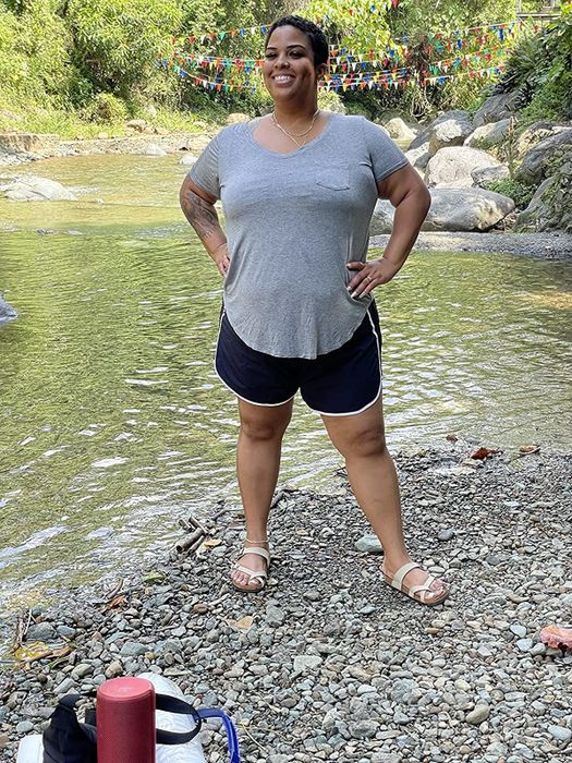 a reviewer showcasing black shorts paired with a grey top
