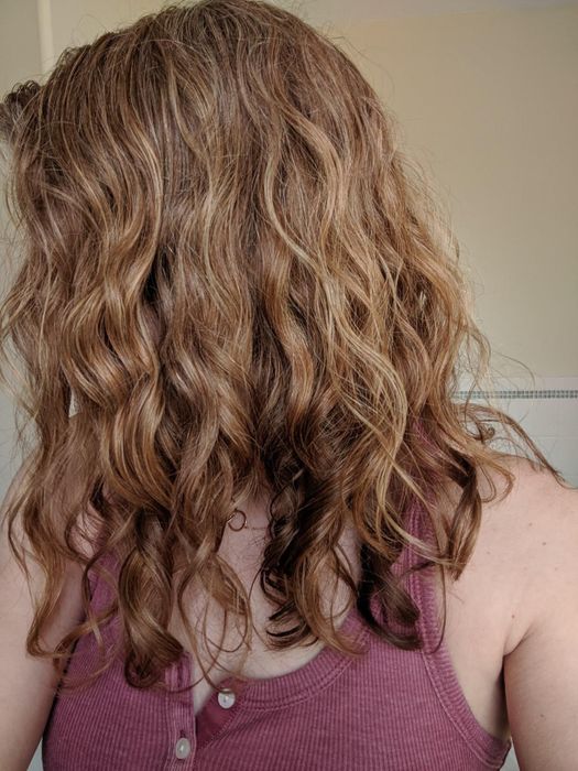 reviewer with wavy brunette hair