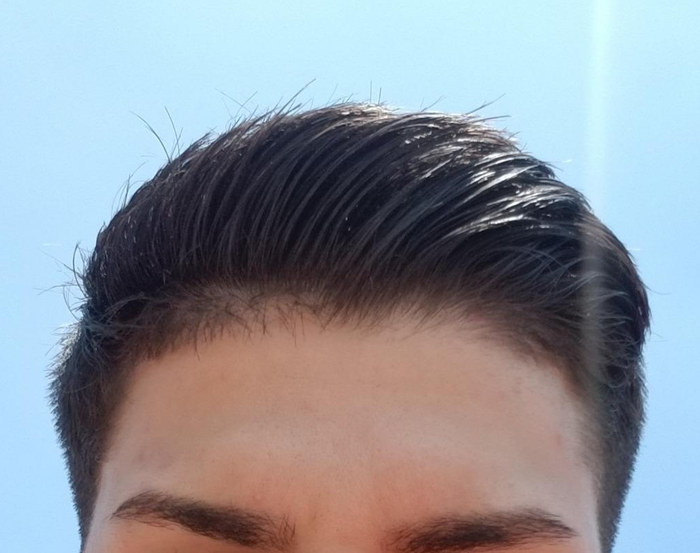 reviewer showcasing hair styled with clay pomade