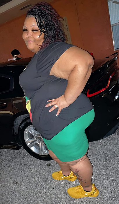 A reviewer showcasing green biker shorts