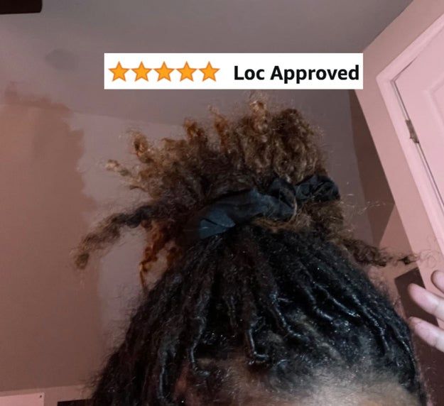 A close-up shot of locs tied into a bun with a black hair tie, accompanied by a five-star rating and the text 