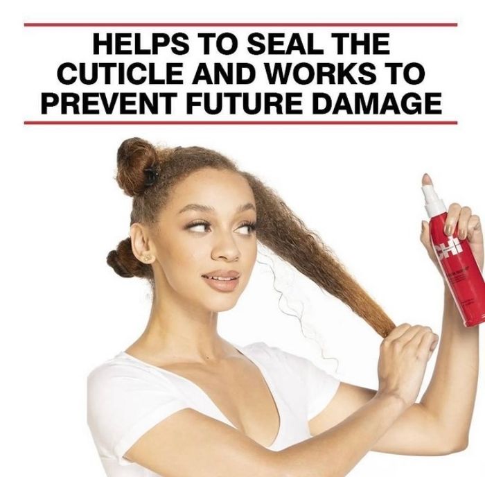 A model spraying a hair product labeled "Helps to seal the cuticle and works to prevent future damage" onto their hair