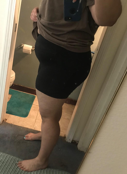 A reviewer modeling black biker shorts