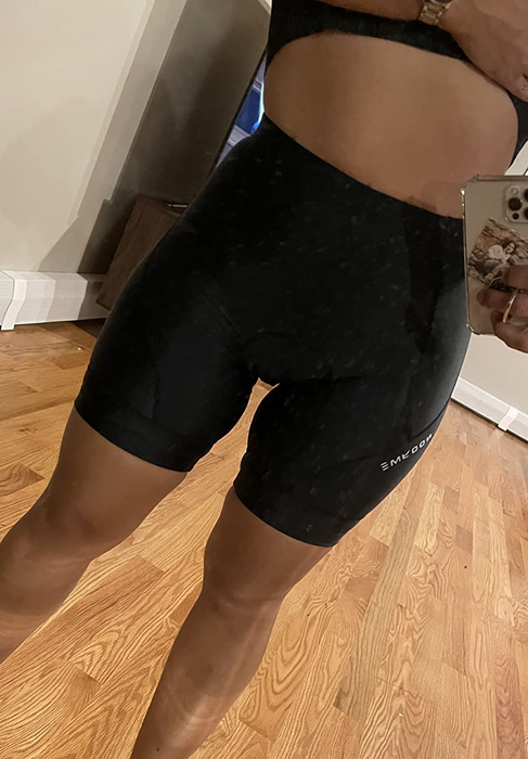 A reviewer showcasing black biker shorts