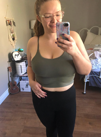 A reviewer is seen wearing the green version of the tank.