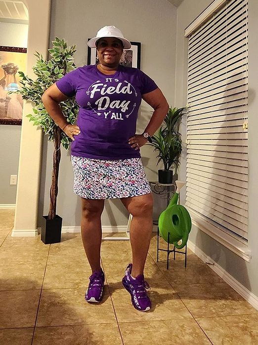 A reviewer modeling a patterned skort paired with a purple top
